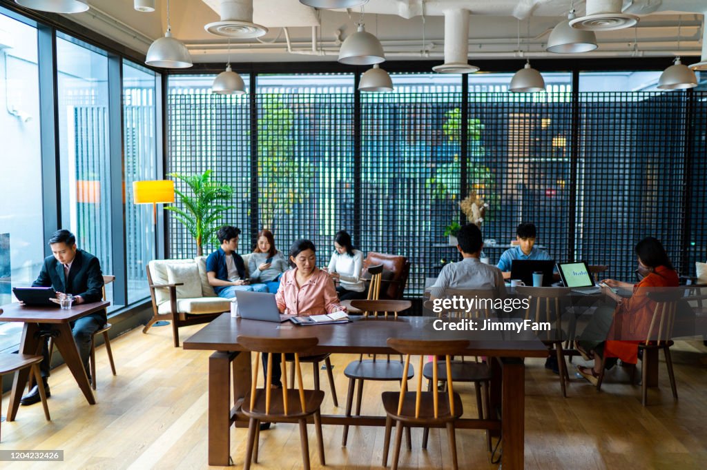 Asians Millennials busy working in co-working space.