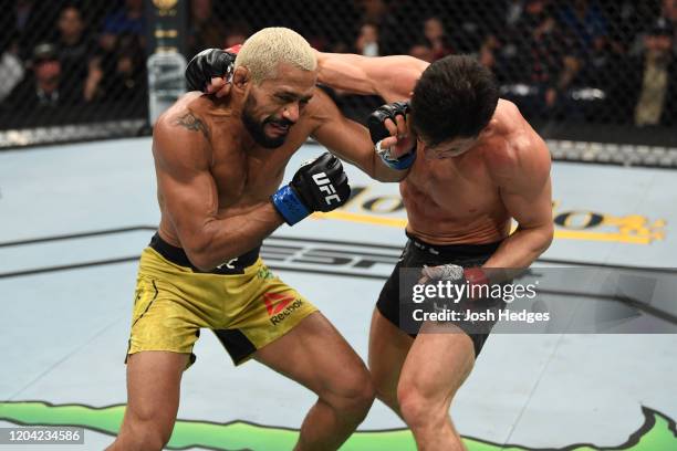 Joseph Benavidez punches Deiveson Figueiredo in their flyweight championship bout during the UFC Fight Night event at Chartway Arena on February 29,...