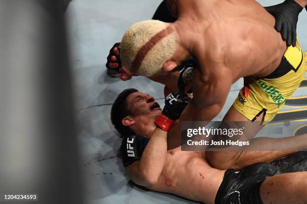 Deiveson Figueiredo punches Joseph Benavidez in their flyweight championship bout during the UFC Fight Night event at Chartway Arena on February 29,...