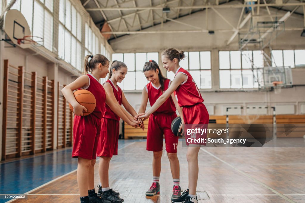 Female School Basketball Team Huddling
