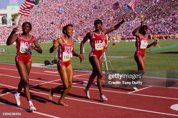 Lillie Leatherwood, Sherri Howard, Valerie Briso-Hooks, and Chandra Chesseborough of the United States celebrate winning the Women's 4 × 400 metre...