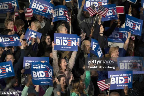 Attendees cheer while holding placards during a primary-night rally with former Vice President Joe Biden, 2020 Democratic presidential candidate, in...