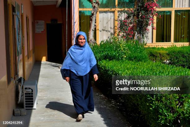In this photograph taken on February 26 Cultural Manager for Women's Affairs Department Torpekay Shinwari walks outside her office in Jalalabad. - As...