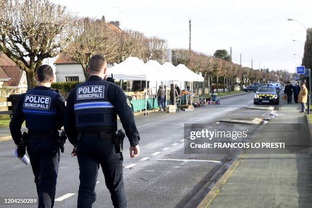 French police and gendarme officers evacuate the market of Crepy-in-Valois on March 1 following the outbreak of COVID-19, caused by the novel...