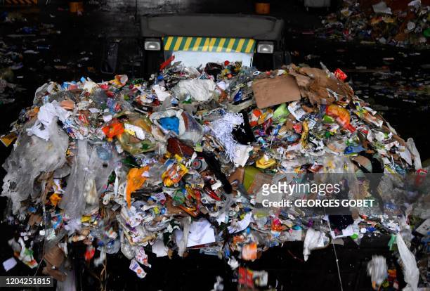 Backhoe moves recyclable wastes stored in a warehouse of Mornac's waste sorting facility, Southwestern France, on Febraury 25, 2020. The Atrion...