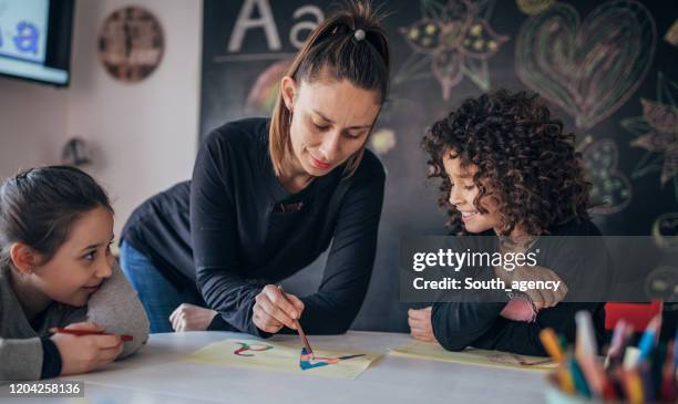 Learning Kids Writing Kids Learning Writing In Preschool High-Res Stock Photo - Getty Images