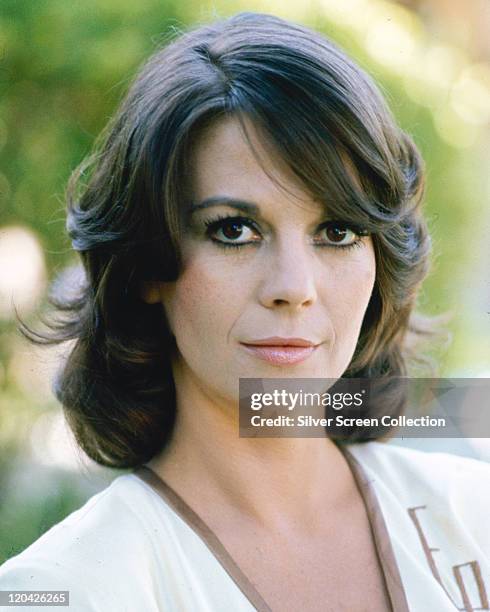 Headshot of Natalie Wood , US actress, wearing a white top with brown trim around the collar, circa 1980.