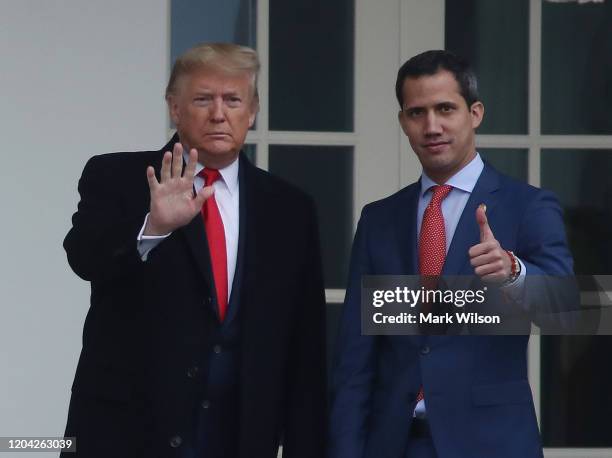 President Donald Trump walks with Interim President of the Bolivarian Republic of Venezuela, after his arrival at the White House, on February 5,...