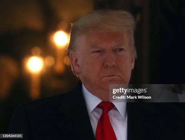 President Donald Trump walks out of the White House to greet Interim President of the Bolivarian Republic of Venezuela, at the South Portico of the...