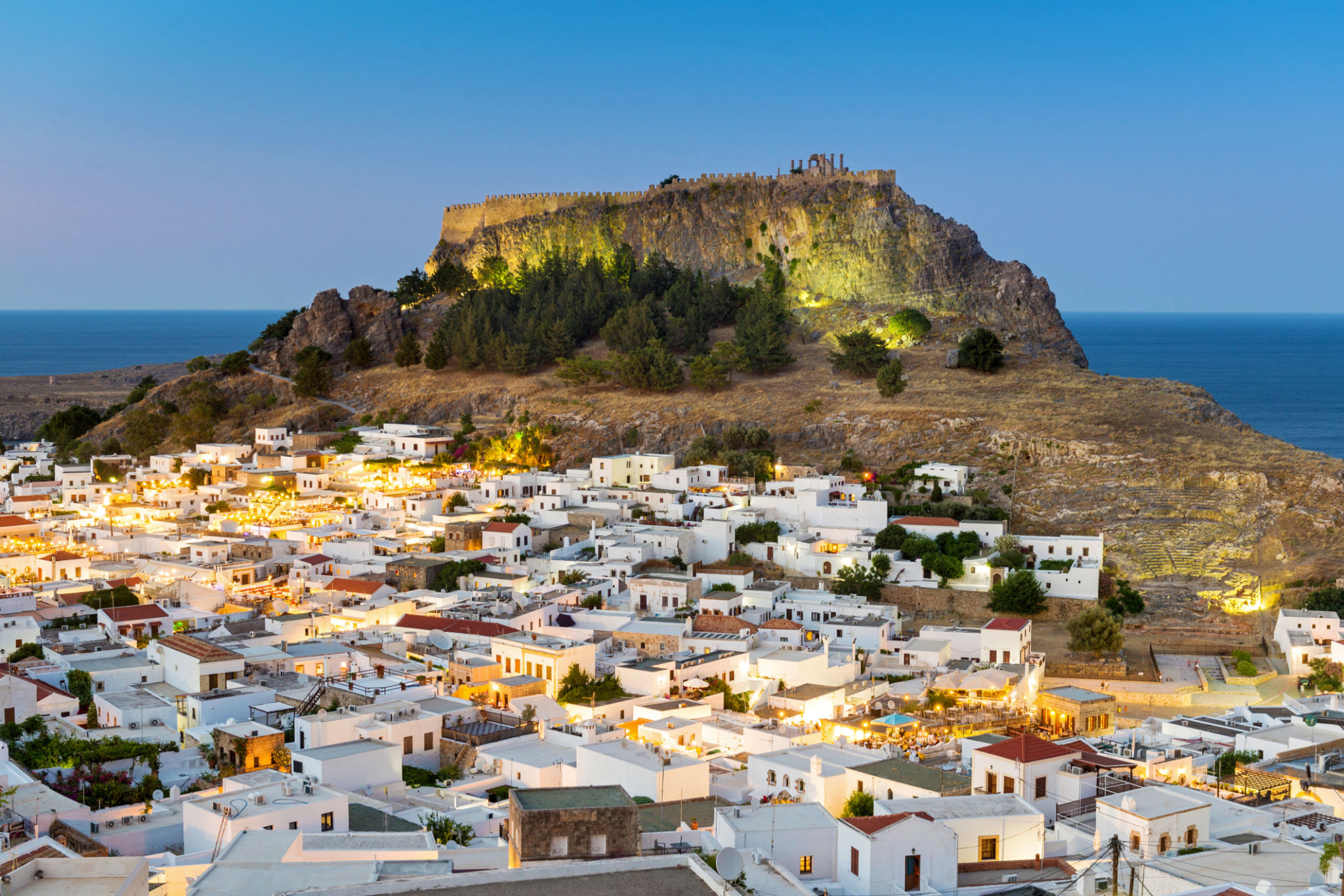 White rooftops of Lindos with the Acropolis of Lindos, Rhodes, Dodecanese, Greek Islands, Greece, Europe White rooftops of Lindos with the Acropolis of Lindos, Rhodes, Dodecanese, Greek Islands, Greece, Europe