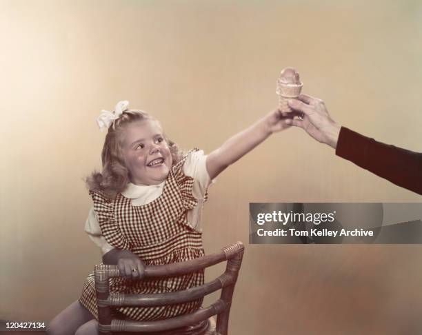 girl taking ice cream cone from man's hand, smiling - 1948 stock pictures, royalty-free photos & images