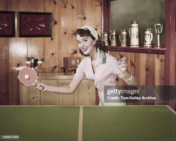 young woman playing table tennis, smiling, portrait - vintage 1950s woman stock pictures, royalty-free photos & images