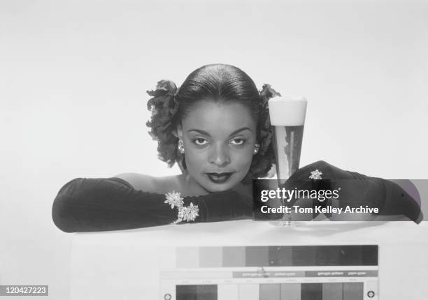 young woman holding beer glass, smiling, portrait - evening glove stock pictures, royalty-free photos & images