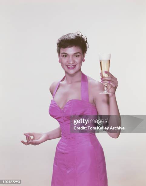 young woman holding glass of beer, smiling, portrait - 1956 - fotografias e filmes do acervo