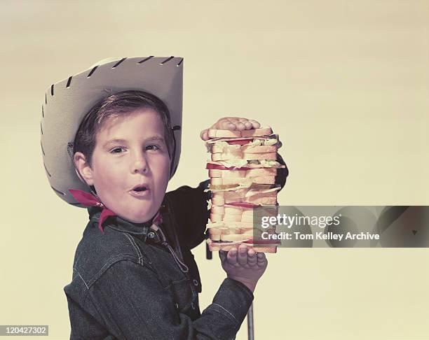 boy wearing cowboy hat holding big sandwich, portrait - 1957 stock pictures, royalty-free photos & images