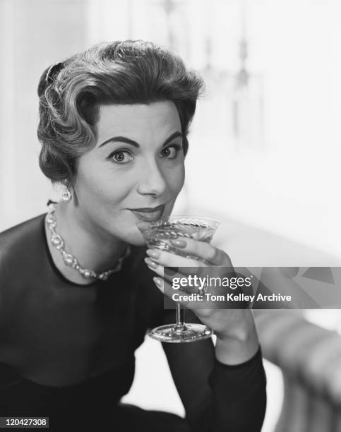 woman holding glass of drink, smiling, portrait  - archival alcohol stock pictures, royalty-free photos & images