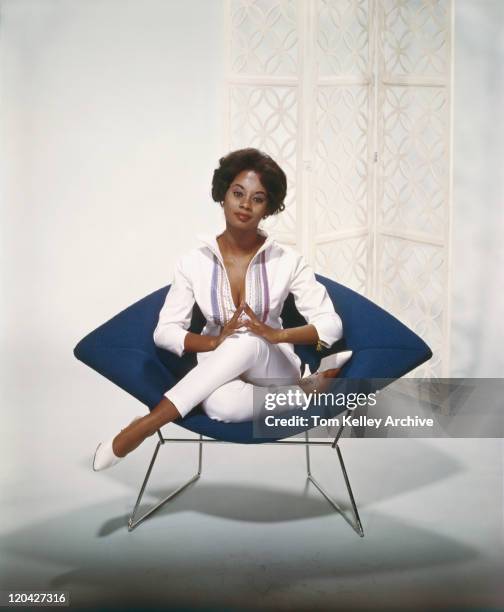 young woman sitting on armchair, smiling, portrait - 1960 stock pictures, royalty-free photos & images