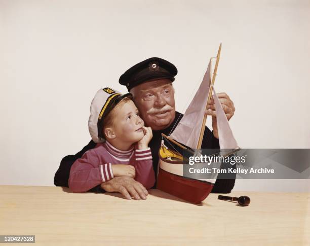 grandfather and grandson with model ship - 1961 stock pictures, royalty-free photos & images