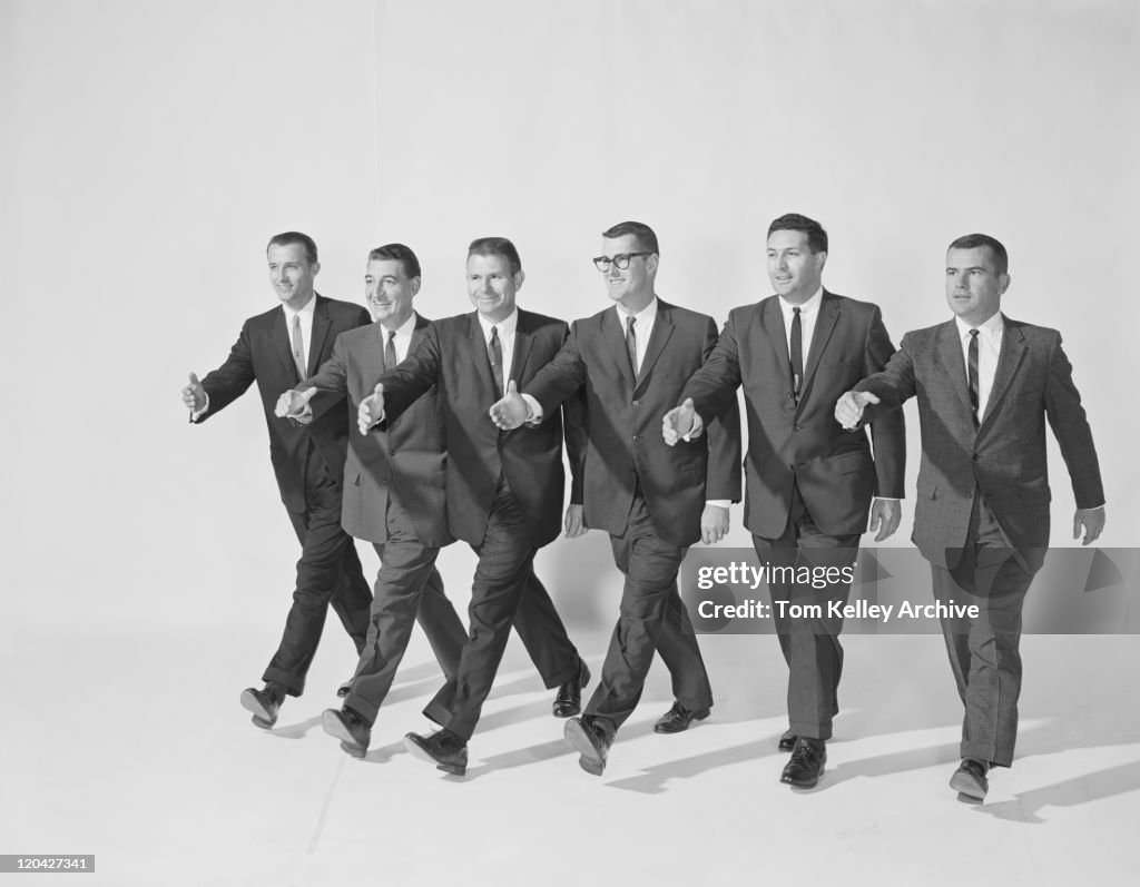 Businessmen extending hand to shake, smiling