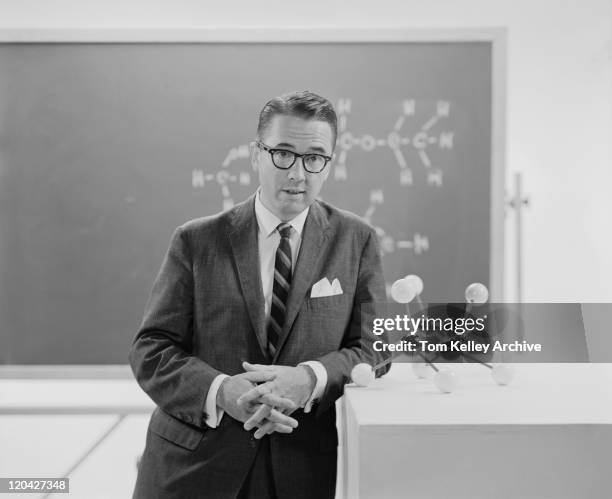 man standing beside molecule model, portrait - archival 1960s stock pictures, royalty-free photos & images