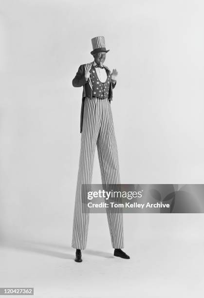 man standing on stilts, smiling, portrait - stilt stock pictures, royalty-free photos & images