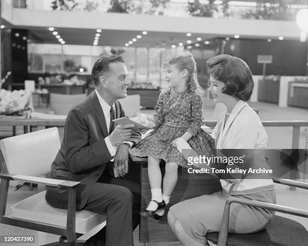 niña sentada sobre los padres junto a su mesa con - 1962 fotografías e imágenes de stock