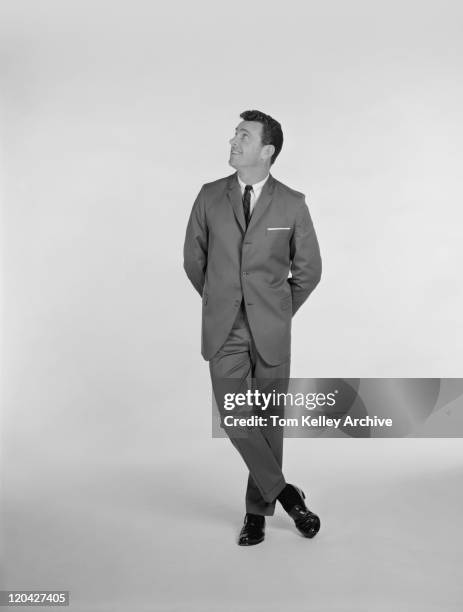 businessman standing on white background, smiling - looking up vintage stock pictures, royalty-free photos & images