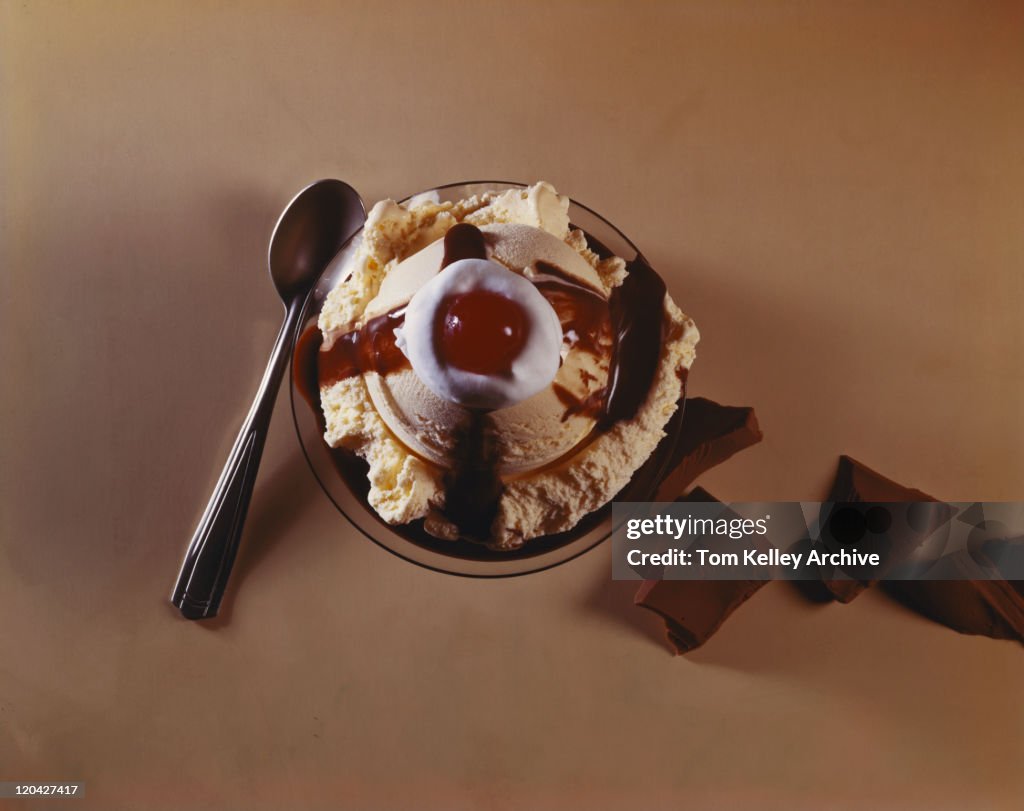 Ice cream with chocolate pieces and spoon, close-up