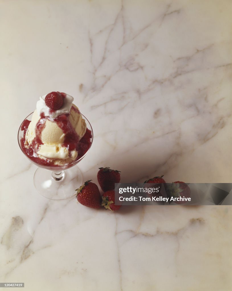 Cup of ice cream with strawberries, close-up