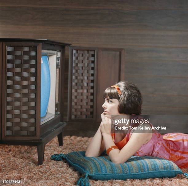 young woman watching television - vintage television set stock pictures, royalty-free photos & images