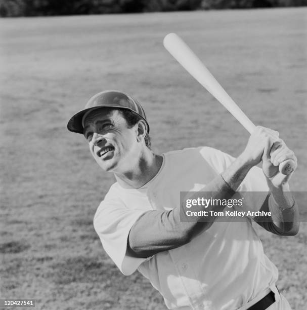 baseball player swinging baseball bat - sports archive stockfoto's en -beelden