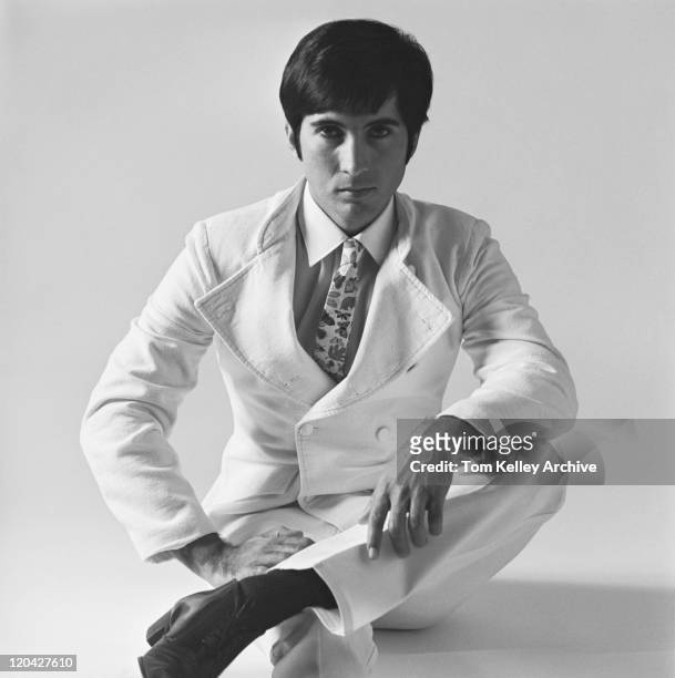 young man sitting on white background, portrait - archival 1960s stock pictures, royalty-free photos & images
