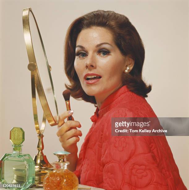 mujer agarrando maquillaje cepillo, retrato - años 60 fotografías e imágenes de stock