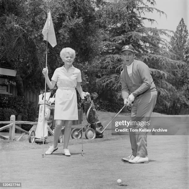 mature man putting ball into hole - archival sports stock pictures, royalty-free photos & images