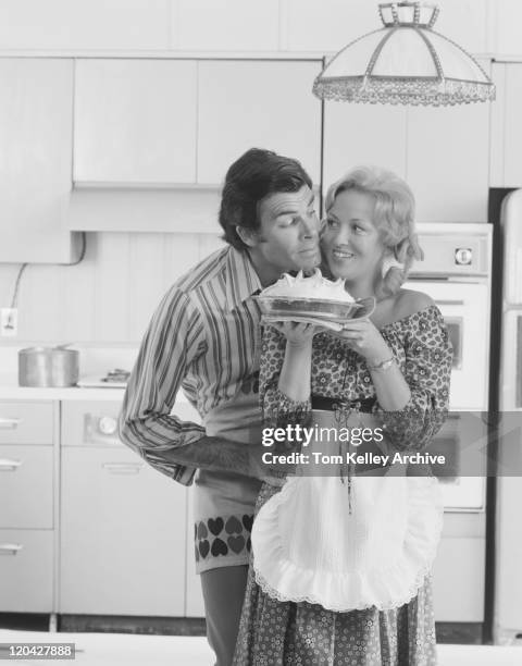 couple with meringue in kitchen, smiling - 1974 stock pictures, royalty-free photos & images