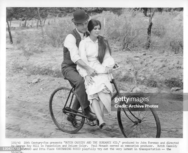Paul Newman riding bike with Katharine Ross in a scene from the film 'Butch Cassidy And The Sundance Kid', 1969.