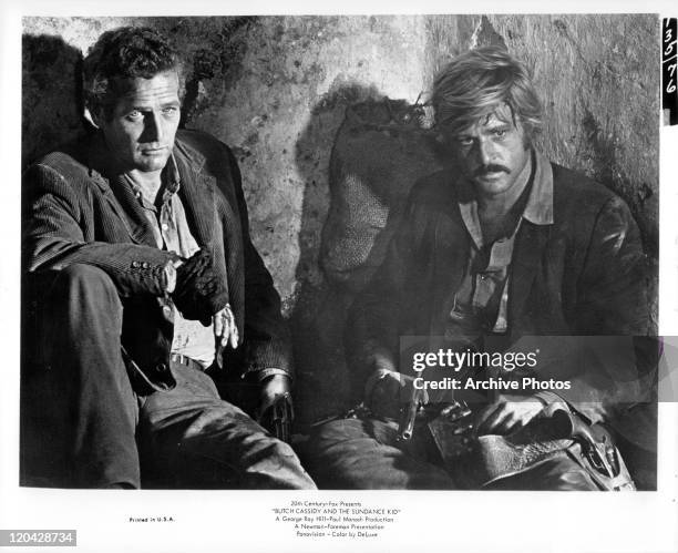 Paul Newman sitting with Robert Redford in a scene from the film 'Butch Cassidy And The Sundance Kid', 1969.