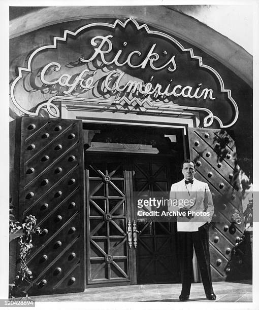 Humphrey Bogart stands outside Rick's Cafe in a scene from the film 'Casablanca', 1942.