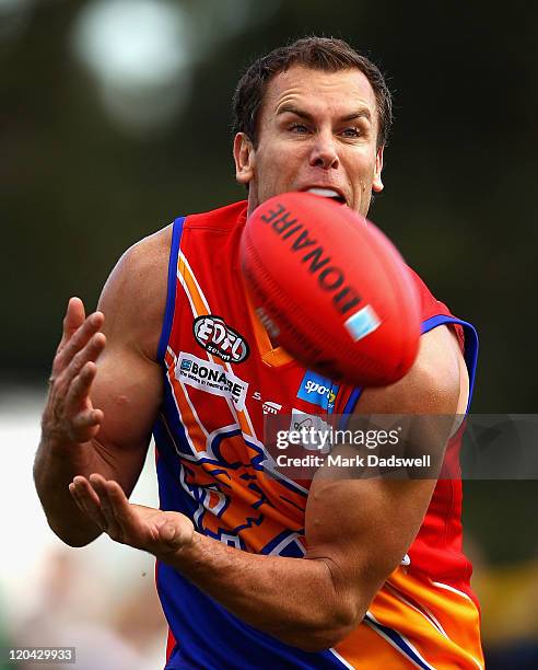 Wayne Carey playing for the Maribyrnong Lions marks on his chest after a strong lead during the Essendon Distrct Football League AFL match against...