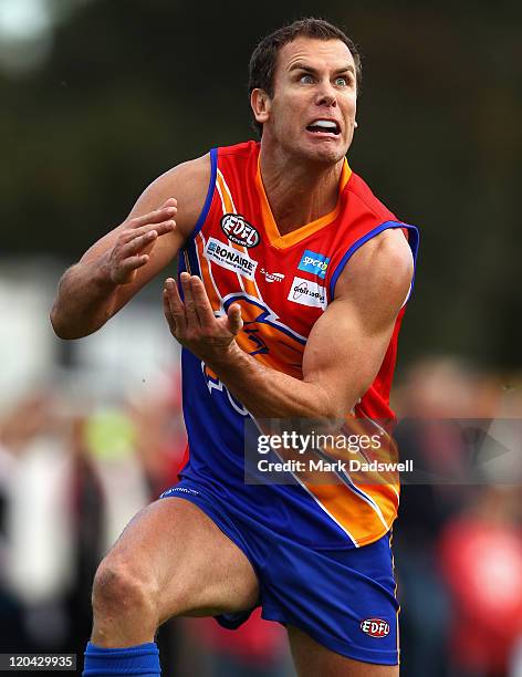 Wayne Carey playing for the Maribyrnong Lions marks on his chest after a strong lead during the Essendon Distrct Football League AFL match against...