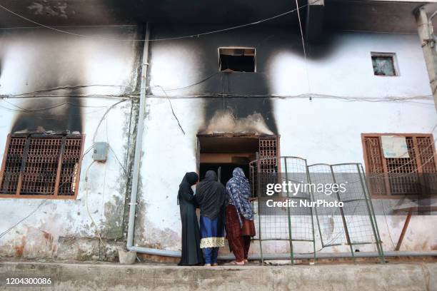 Indian muslims look inside a charred mosque after it was set on fire by a mob during riots in Mustafabad area of New Delhi, India on 29 February...