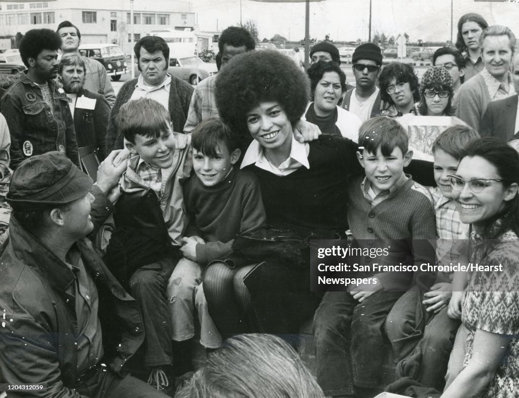 Angela Davis with Roger McAfee, Mark McAfee (10) Eric McAfee (9), Davis, Adam McAfee (8), David McAfee (40 and Mrs. Roger McAfee March 2, 1972 Photo ran 03/03/1972, p. 3