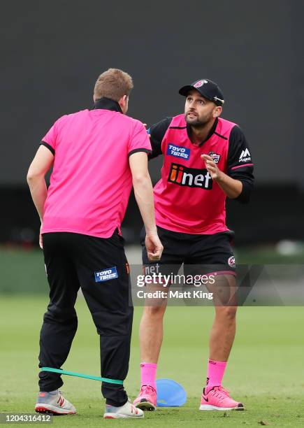 Steve Smith and Nathan Lyon stretch during a Sydney Sixers Big Bash League training session at Sydney Cricket Ground on February 06, 2020 in Sydney,...