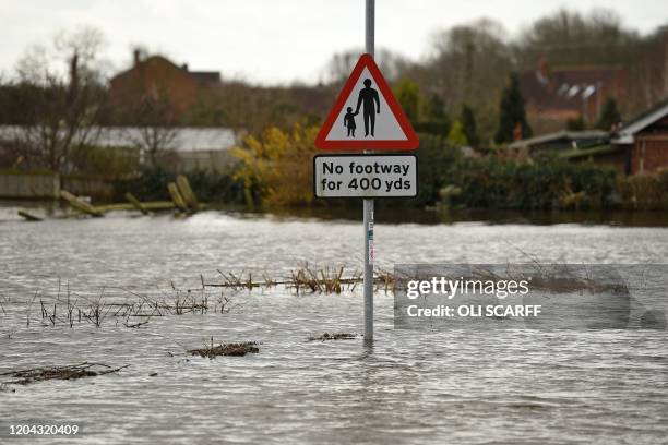 No Footway sign is seen as floodwaters rise in East Cowick, northern England on March 1, 2020 after Storm Jorge brought more rain and flooding to...