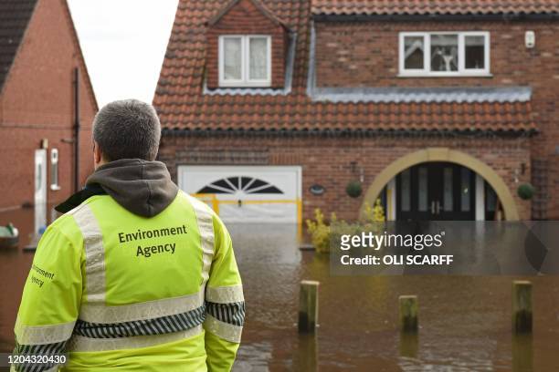 Environment Agency staff check on the rising floodwaters in East Cowick, northern England on March 1, 2020 after Storm Jorge brought more rain and...