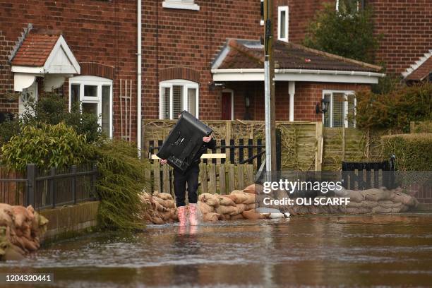 Sandbags protect houses from floodwaters in East Cowick, northern England on March 1, 2020 after Storm Jorge brought more rain and flooding to parts...