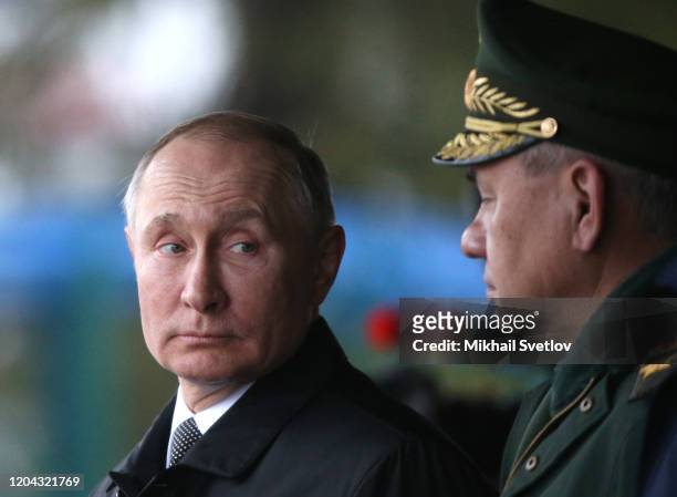 Russian President Vladimir Putin looks on Defence Minister Sergei Shoigu during the military parade at the 76th Guards Air Assault Division in Pskov,...