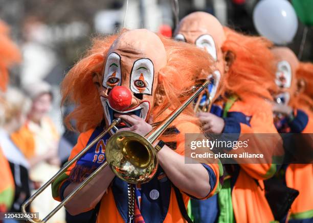 March 2020, Baden-Wuerttemberg, Weil am Rhein: Musicians of the Guggemusik Notehobler from Weil am Rhein walk in Waggis disguise during the parade of...
