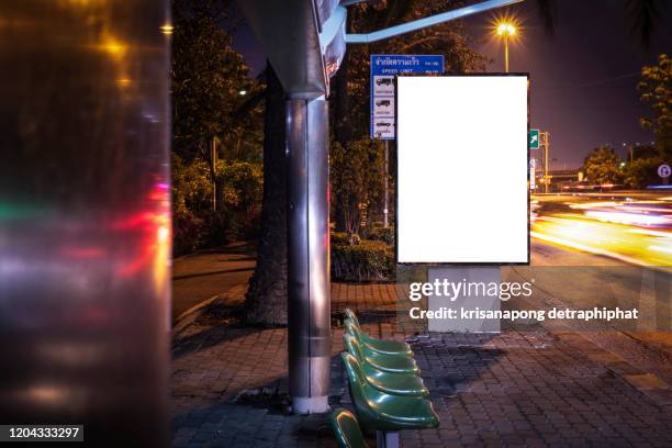 blank billboard on city street at night. outdoor advertising - bus advertising stockfoto's en -beelden