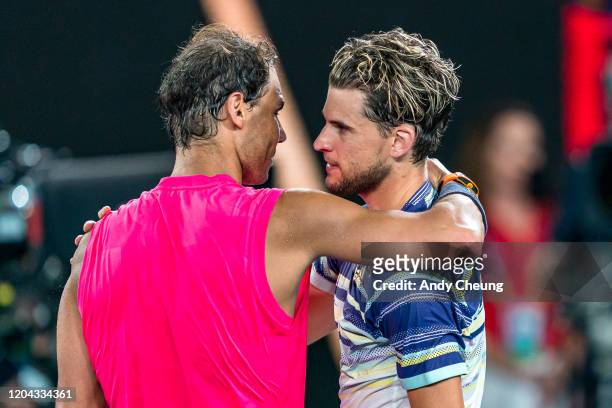 Rafael Nadal of Spain embraces Dominic Thiem of Austria after their singles match on day ten of the 2020 Australian Open at Melbourne Park on January...